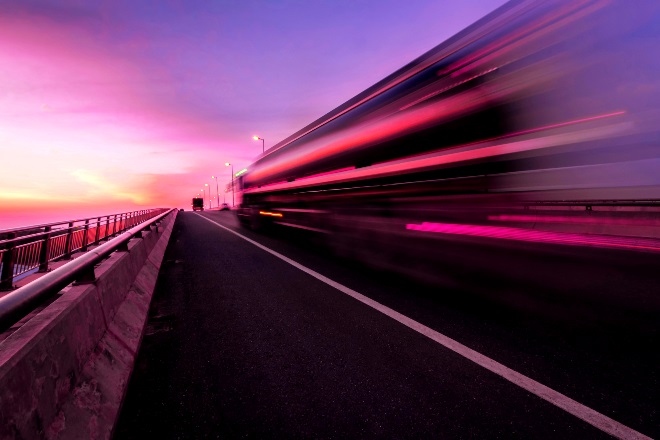 A large commercial vehicle driving on the road ahead